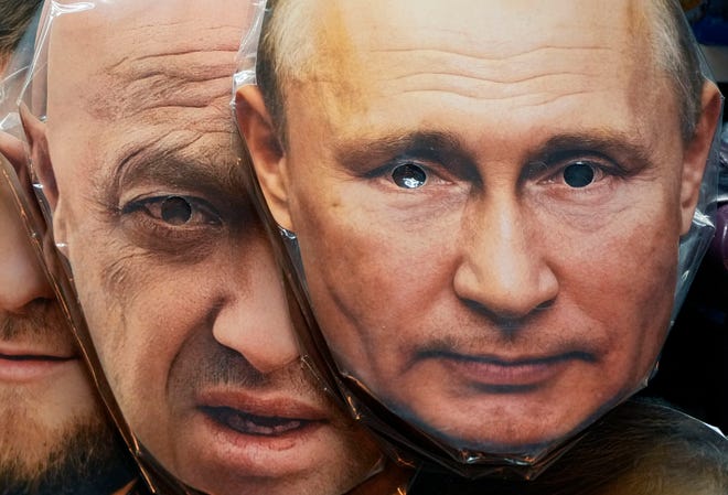 Face masks depicting Russian President Vladimir Putin, right, and Wagner Group leader Yevgeny Prigozhin are displayed at a souvenir shop in St. Petersburg, Russia, on June 4, 2023.