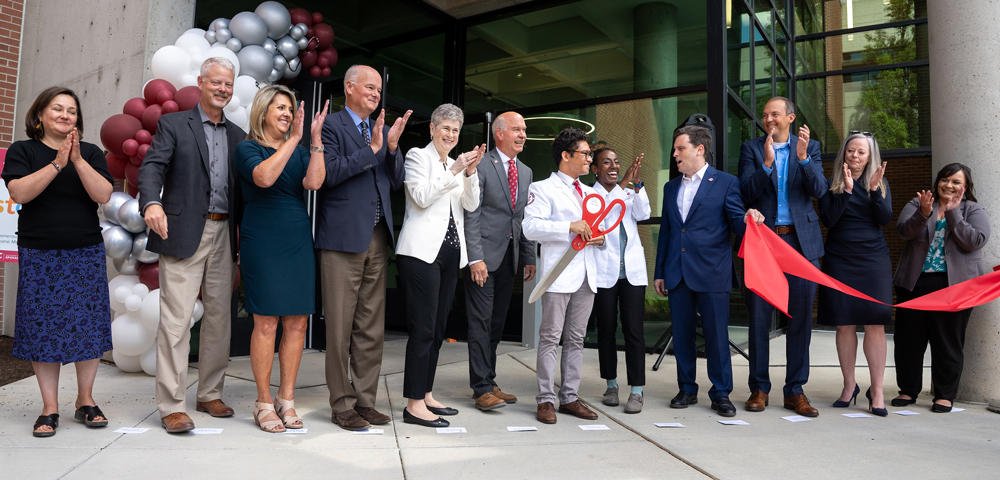 WSU and Spokane officials and other dignitaries applaud after a ribbon-cutting ceremony.