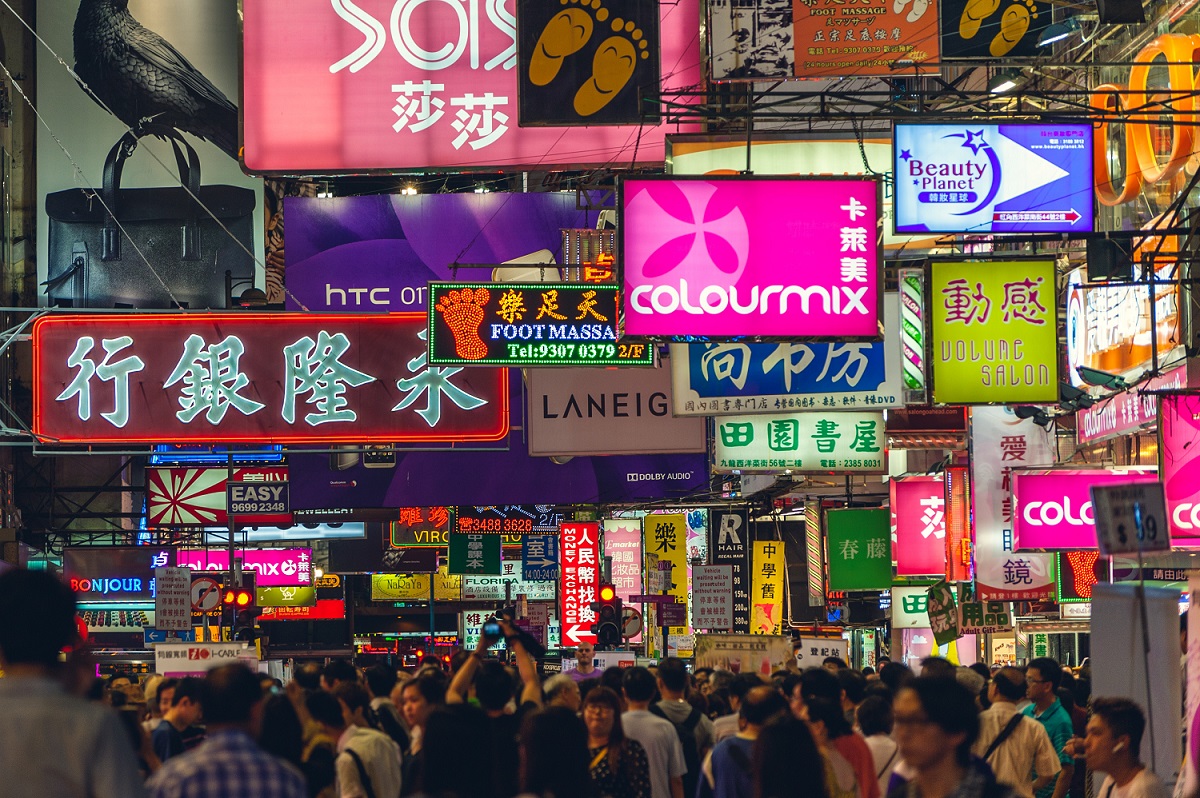 Unlocking Cross-border Payments: How AI Legalese Decoder Enhances China-Hong Kong e-CNY Transactions 2 Neon signs on a street in Kowloon, Hong Kong, at night time.