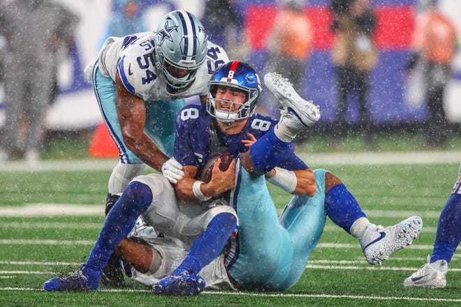 New York Giants quarterback Daniel Jones (8) is sacked by Dallas Cowboys linebacker Micah Parsons (11) during the second half at MetLife Stadium.