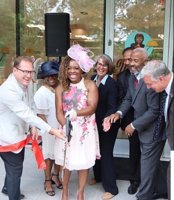 Group of people standing together for a ribbon cutting meeting