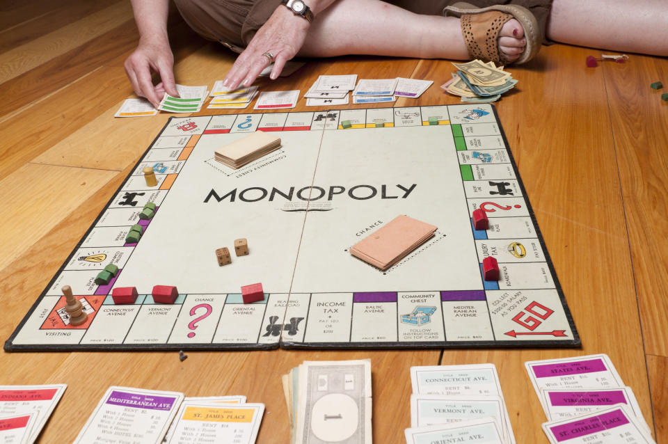 Phoenix, United States - June 18, 2011: Monopoly is a board game in which the players purchae property, build houses and hotels, and charge for other players who land on their property. The winner is determined when one player has so much money and property that the other players are bankrupted.