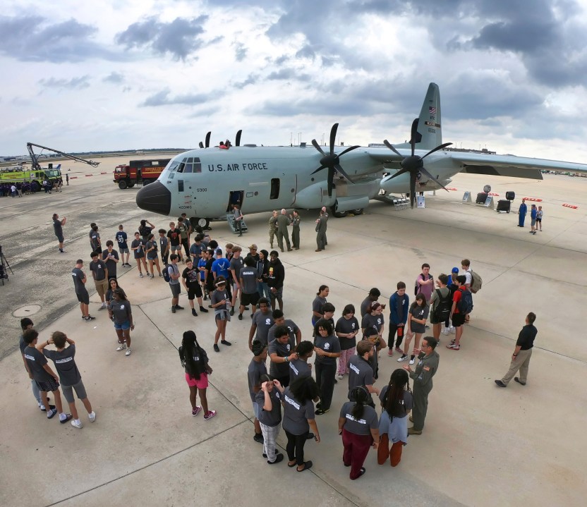 Students from Public Service Academy of Winter Springs get information about the U.S. Air Force Reserve 53rd Weather Reconnaissance Squadron's WC-130J aircraft during a stop at Orlando Sanford International Airport, in Sanford, Fla., Friday, May 10, 2024. The plane is USAF's "Hurricane Hunter" — a flying science lab that navigates into the heart of tropical cyclones— collecting real-time storm data. (Joe Burbank /Orlando Sentinel via AP)