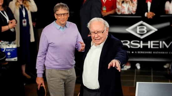 Latest news on August 16, 2024: Berkshire Hathaway CEO Warren Buffett (R) talks to Microsoft founder Bill Gates as they play Bridge during the Berkshire Hathaway annual meeting weekend.