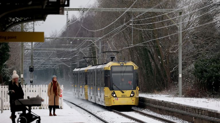 Commuters waiting in Manchester.