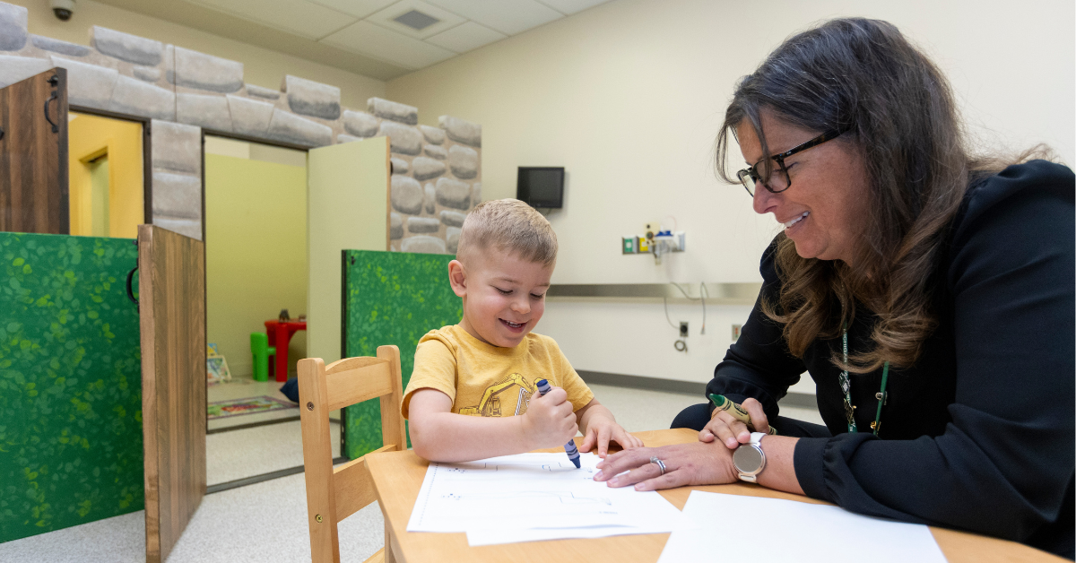 Barbara Thompson, PhD, with a child research participant in the SEND Lab.